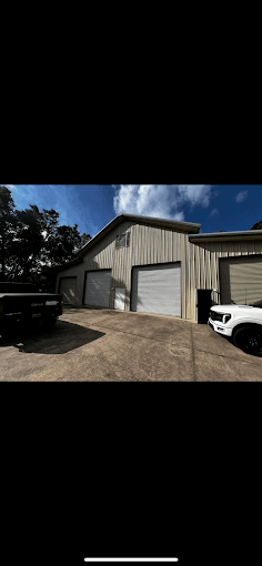 Commercial metal building with white garage doors