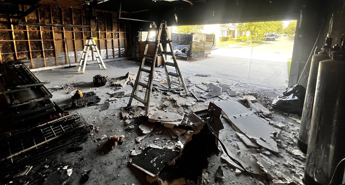 Fire damaged garage interior before restoration