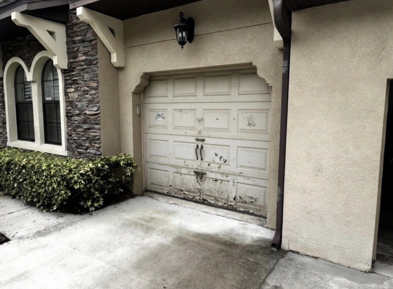 Before: Old rusty dented garage door